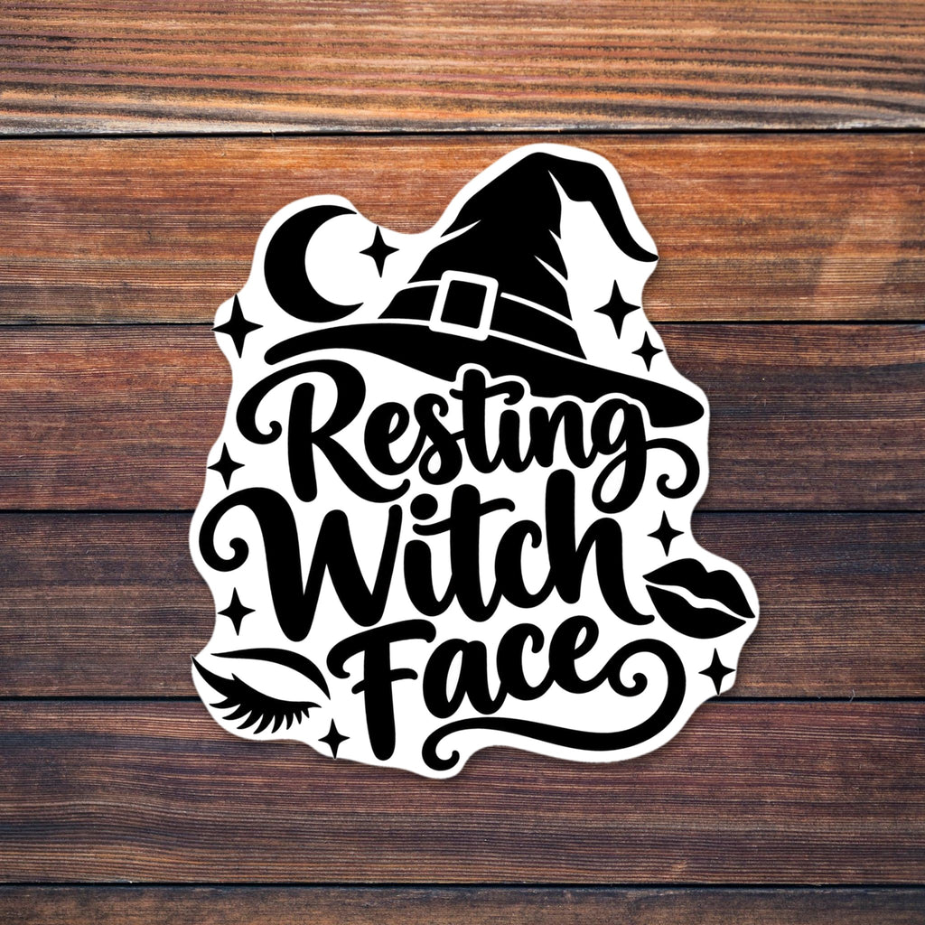 Black script text reading Resting Witch Face beneath a buckled witch hat, with a crescent moon, sparkle stars, a closed eye with lashes, lips and decorative swirls shown on a wooden table